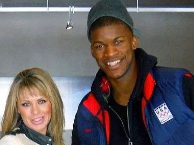 Jimmy Butler is wearing a blue jacket with USA Olympic badge on it and Michelle Lambert is wearing a white jacket.